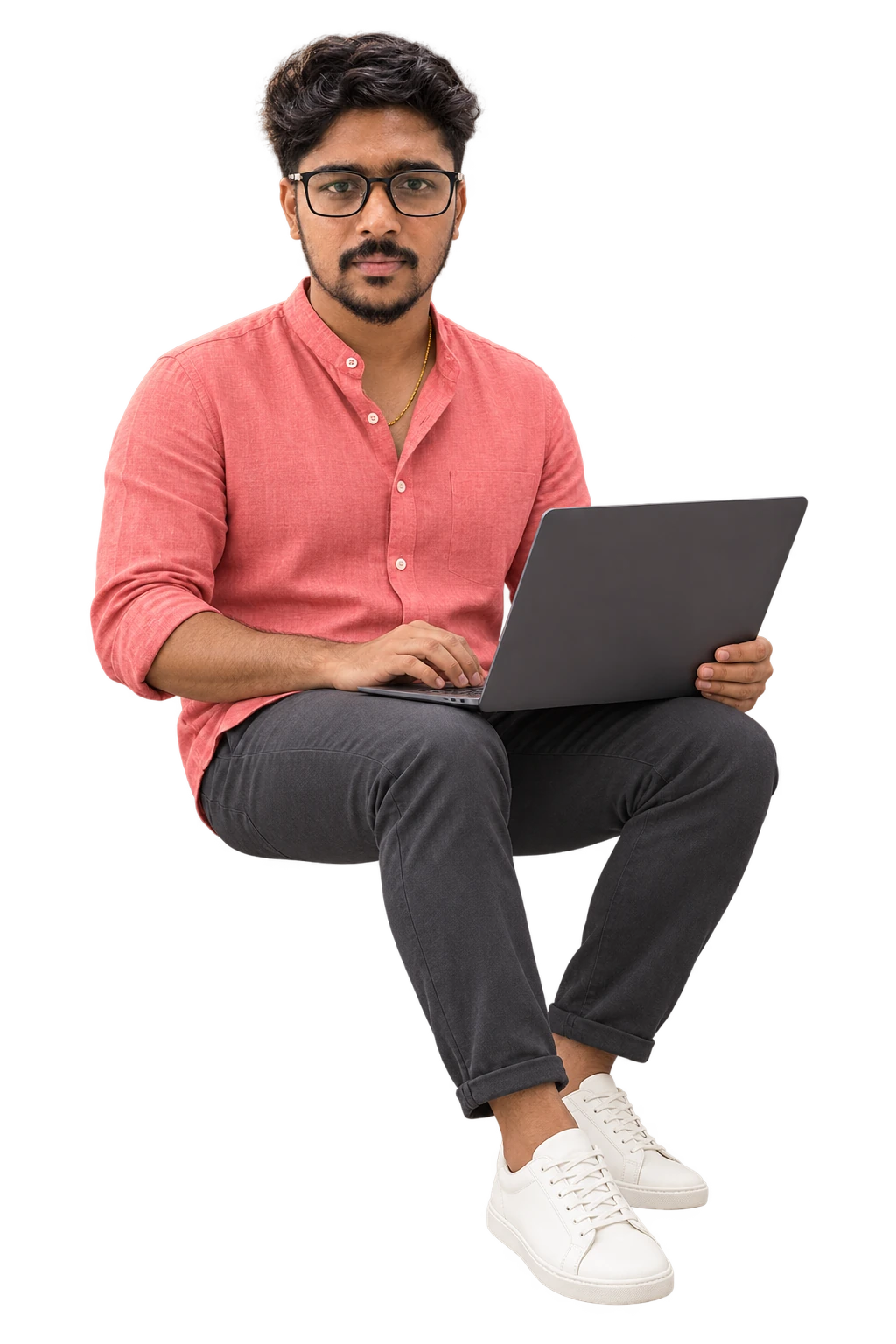 Ram seated with a laptop, in his coral shirt, charcoal trousers and off-white sneakers